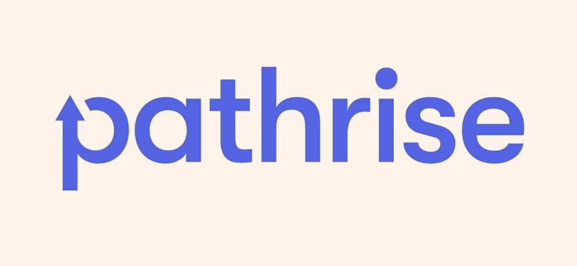 The image displays the logo for 'Pathrise' on a light beige background. The logo features the word 'pathrise' in lowercase, sans-serif, bold font in a violet color. The 'p' in 'path' is uniquely designed with an upward arrow integrated into its spine, and the dot on the 'i' is represented by a circle slightly detached from the letter, floating above it.